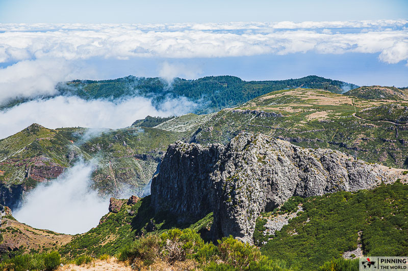 View from Pico Arieiro viewing deck of surrounding cloud covered valleys and distant towns